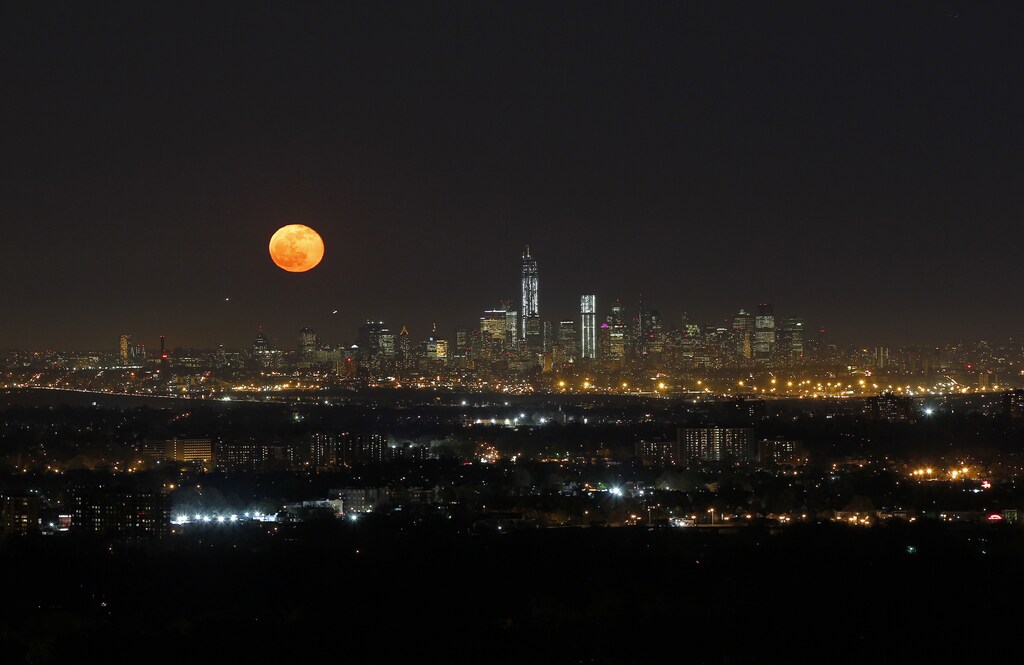 The moon rises over New York, as seen from the Eagle Rock Reservation in West Orange, New Jersey in this April 26, 2013 file photo. New York City is iconic in any weather, but the warm season adds a special flavour to its bustling streets, leafy parks and world-famous skyline. The summer is about to draw to a close, as fall begins in the northern hemisphere with the Autumnal Equinox on September 22. Picture taken April 26, 2013.