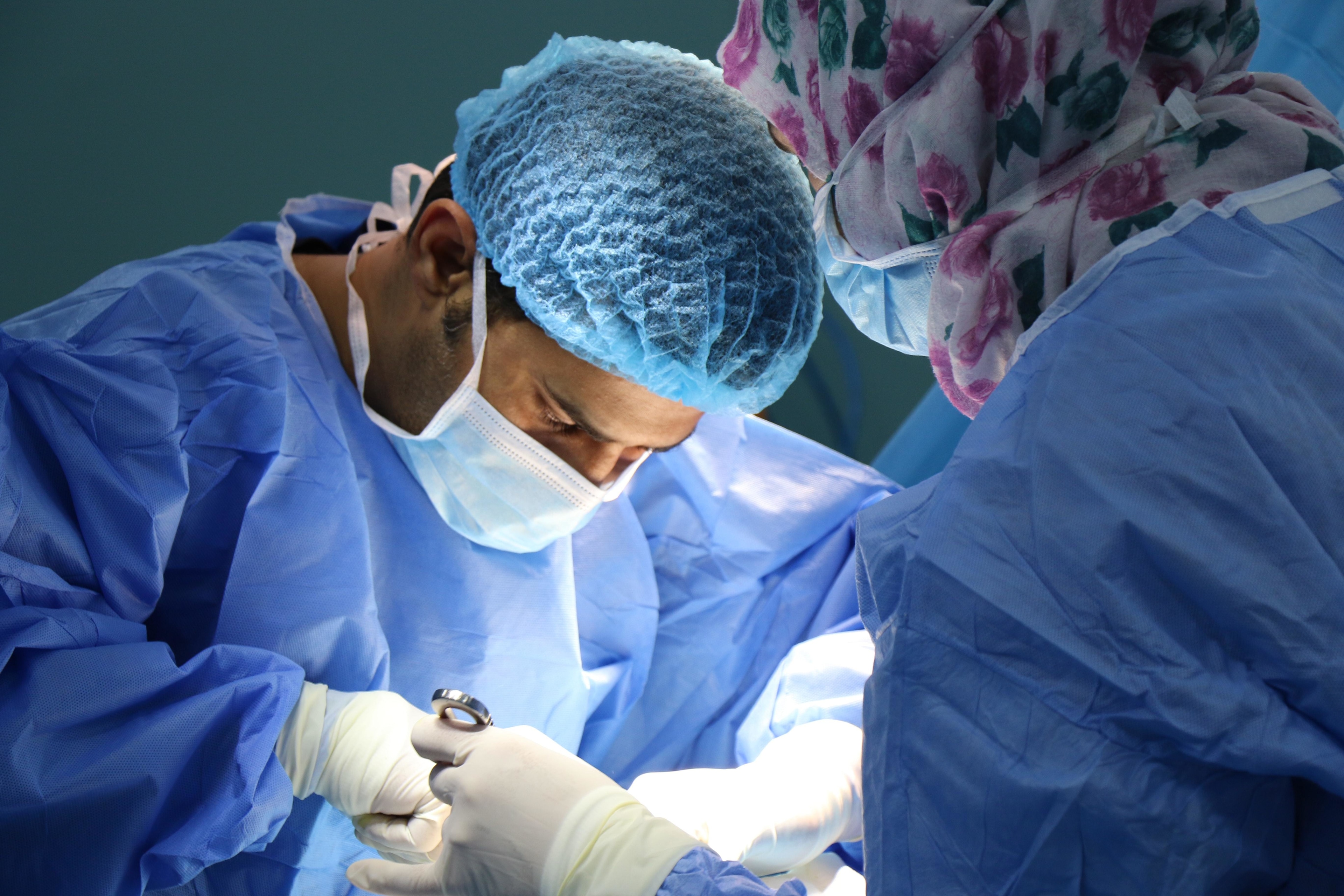 Zoomed in view of a doctor concentrating on a patient.