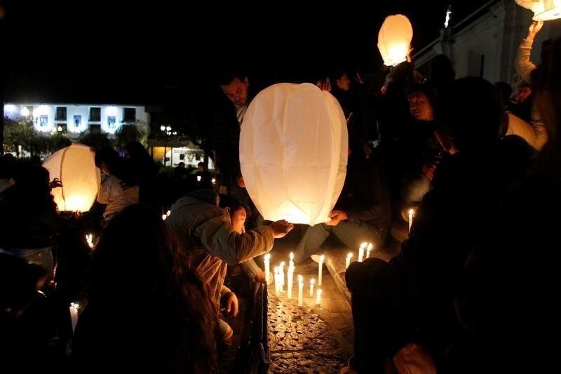 People participate in a candle light vigil for two Ecuadorean journalists and their driver, who were kidnapped last month by Colombian insurgents and were killed, in Quito, Ecuador April 13, 2018. Picture taken April 13, 2018.