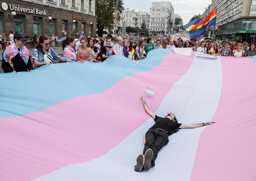 A participant lies on a giant Transgender Pride Flag during the Equality March, organized by the LGBT community in Kiev, Ukraine June 23, 2019. REUTERS/Gleb Garanich TPX IMAGES OF THE DAY - RC1D8925C170