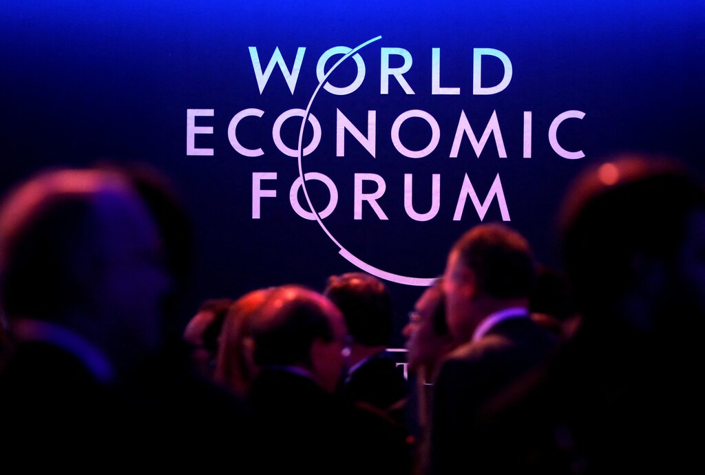 Global Risks report 2022: A logo of the World Economic Forum (WEF) is seen as people attend the WEF annual meeting in Davos, 2018.