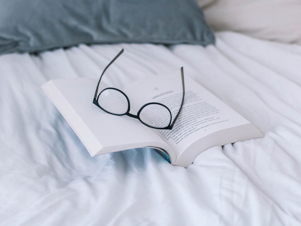 a picture of reading glasses resting on a book
