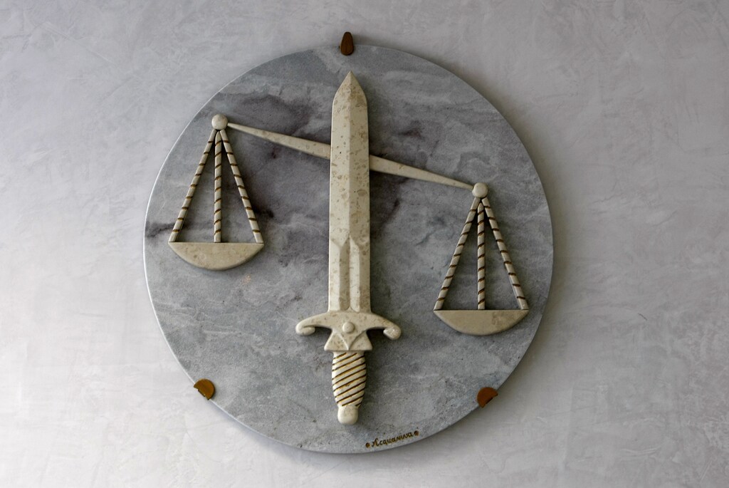 The symbol of Justice, with sword and the scales, is seen in a lawyers cabinet in Nice, southeastern France, October 9, 2009. REUTERS/Eric Gaillard (FRANCE CRIME LAW) - PM1E5A90WJ601