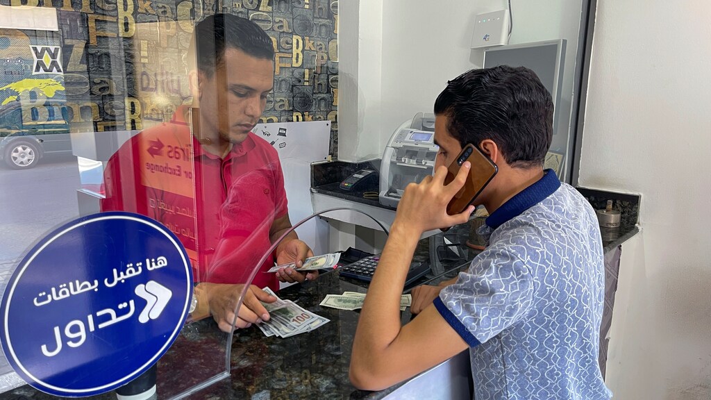 A Libyan customer exchanges U.S. dollars currency at a market shop, in Tripoli, Libya, September 8, 2021 Picture taken September 8, 2021. REUTERS/Hazem Ahmed