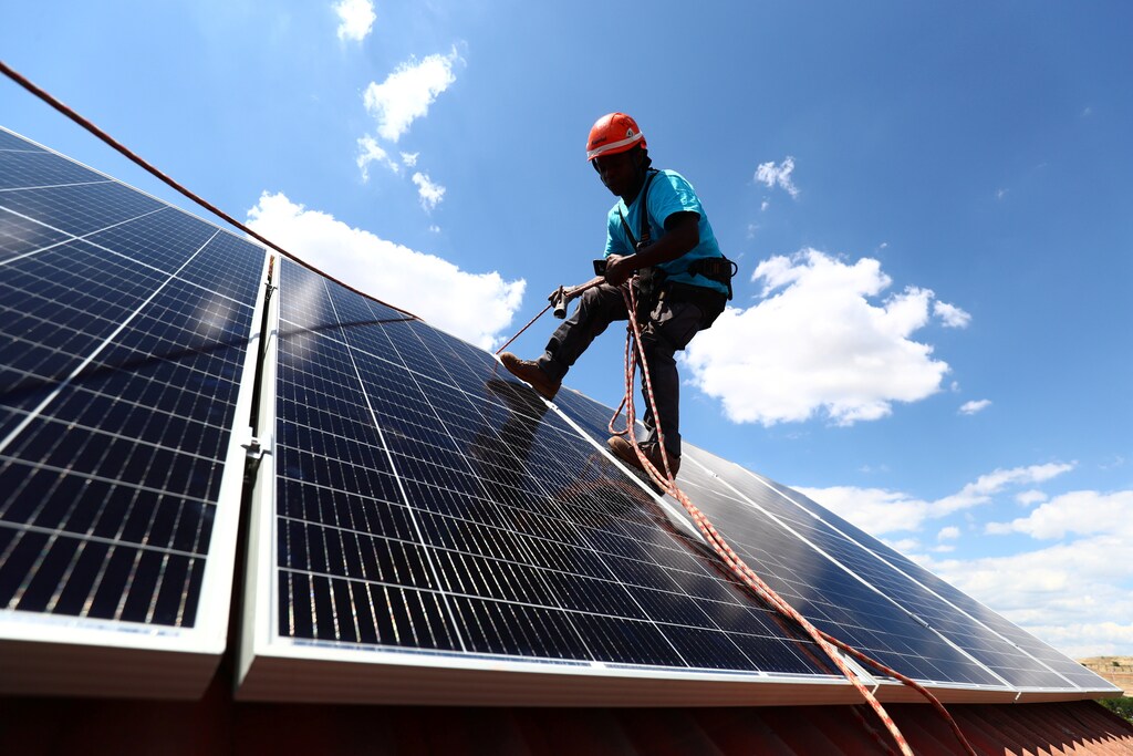 Rodrigue Kauahou, a worker of the installation company Alromar, sets up solar panels on the roof of a home in Colmenar Viejo, Spain June 19, 2020. Picture taken June 19, 2020. REUTERS/Sergio Perez - RC2HPH9UOQOH