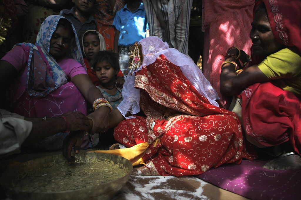 Newly-wed Krishna, 11, attends her wedding ceremony with 13-year-old Kishan Gopal in a village near Kota in the north-western state of Rajasthan, May 16, 2010. Despite a ban on child marriages, children below the legal age tie the knot during Akshaya Tritiya which is considered one of the most auspicious days of the Hindu calendar. REUTERS/Danish Siddiqui (INDIA - Tags: SOCIETY) - GM1E65G1UB601