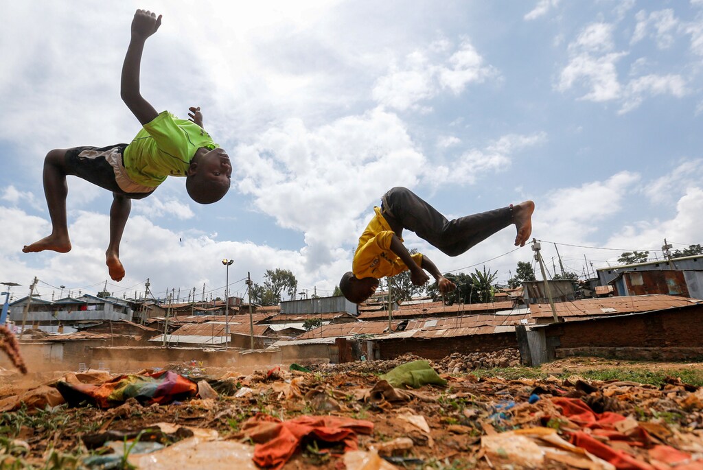 Children flip through the air as they play on dumped plastic materials amid the spread of the coronavirus disease (COVID-19) within Kibera slums in Nairobi, Kenya June 7, 2020. REUTERS/Thomas Mukoya TPX IMAGES OF THE DAY - RC2E4H90JIZ3