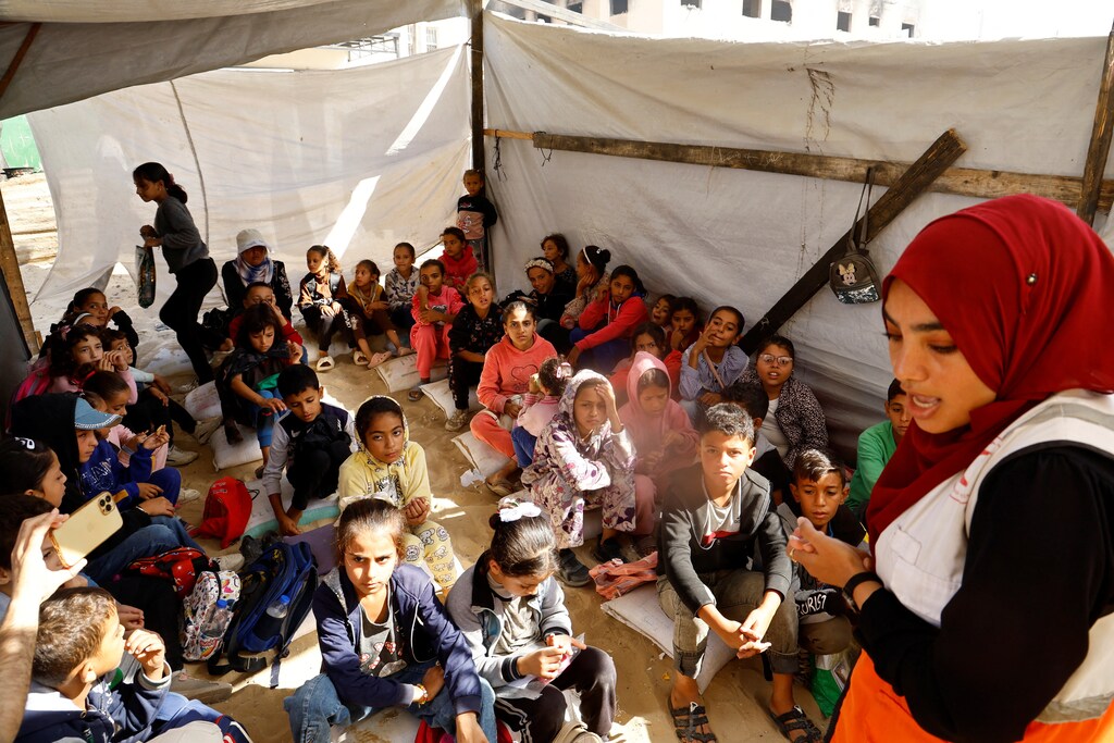 Palestinian children attend a session as part of a campaign organized by the International Committee of the Red Cross (ICRC) in cooperation with the Palestinian Red Crescent Society, aimed at raising awareness about the dangers of unexploded ordnance amid the Israel-Hamas conflict in Khan Younis, southern Gaza Strip, October 28, 2024. REUTERS/Mohammed Salem