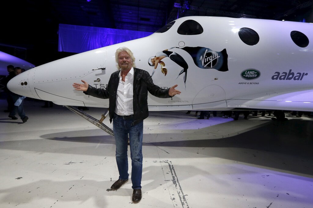 Richard Branson poses after unveiling the new SpaceShipTwo, a six-passenger two-pilot vehicle meant to ferry people into space that replaces a rocket destroyed during a test flight in October 2014, in Mojave, California, United States, February 19, 2016. REUTERS/Lucy Nicholson - GF10000316007