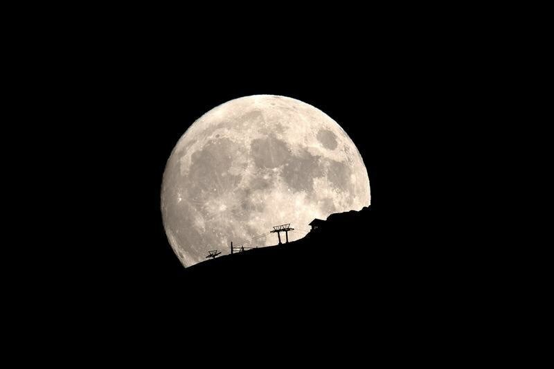 A ski lift at the Kalavrita ski centre on Mount Helmos is silhouetted as the moon rises near the town of Kalavrita, Greece, August 14, 2019. REUTERS/Alkis Konstantinidis TPX IMAGES OF THE DAY - RC1D8F8B5600