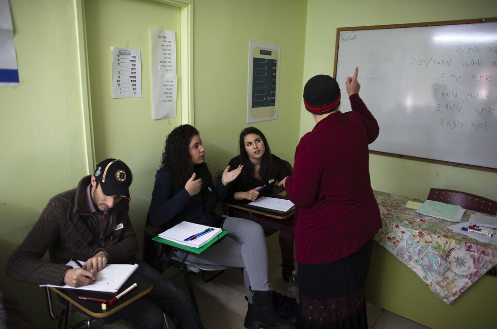 Newly arrived immigrants from France (from L to R) Alexandre Pequito, Myriam Bibas and Aurelie Serraf, all of whom are from Paris, study Hebrew at Ulpan Etzion, the original residential school and absorption centre, which has taught Hebrew to tens of thousands of immigrants since 1949, in Jerusalem, January 20, 2015. For Jews coming to "the Jewish state" from all corners reached by the diaspora, the move may bring relief, but it also raises challenges: a new language and culture, unfamiliar social codes and the difficulty of finding a job. With anti-Semitism rising in France, and their worries stoked by this month's killing of four Jews in a kosher supermarket in Paris, French Jews now make up the largest group of new migrants to Israel. Picture taken January 20, 2015. To match ISRAEL-MIGRATION/FRANCE REUTERS/Ronen Zvulun (JERUSALEM - Tags: POLITICS SOCIETY IMMIGRATION EDUCATION) - GM1EB1R1O7E01