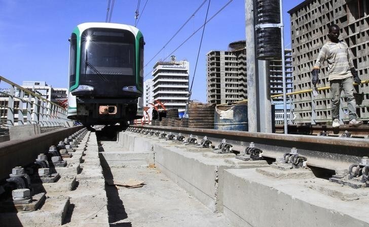 A labourer walks along a Metro-line construction in Ethiopia's capital Addis Ababa February 7, 2015. Chinese workers mingle with Ethiopians putting the finishing touches to a city metro line that cuts through Addis Ababa, one of a series of grand state infrastructure projects that Ethiopia hopes will help it mimic Asia's industrial rise.To match Insight ETHIOPIA-ECONOMY/. Picture taken February 7, 2015. REUTERS/Tiksa Negeri (ETHIOPIA - Tags: TRANSPORT BUSINESS CONSTRUCTION CITYSCAPE)