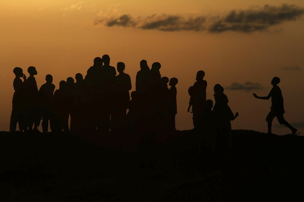 Children play on Dala hill at sunset in the old city district in Nigeria's northern state of Kano September 9, 2010. REUTERS/Akintunde Akinleye (NIGERIA - Tags: SOCIETY CITYSCAPE) - GM1E69A0FFZ01