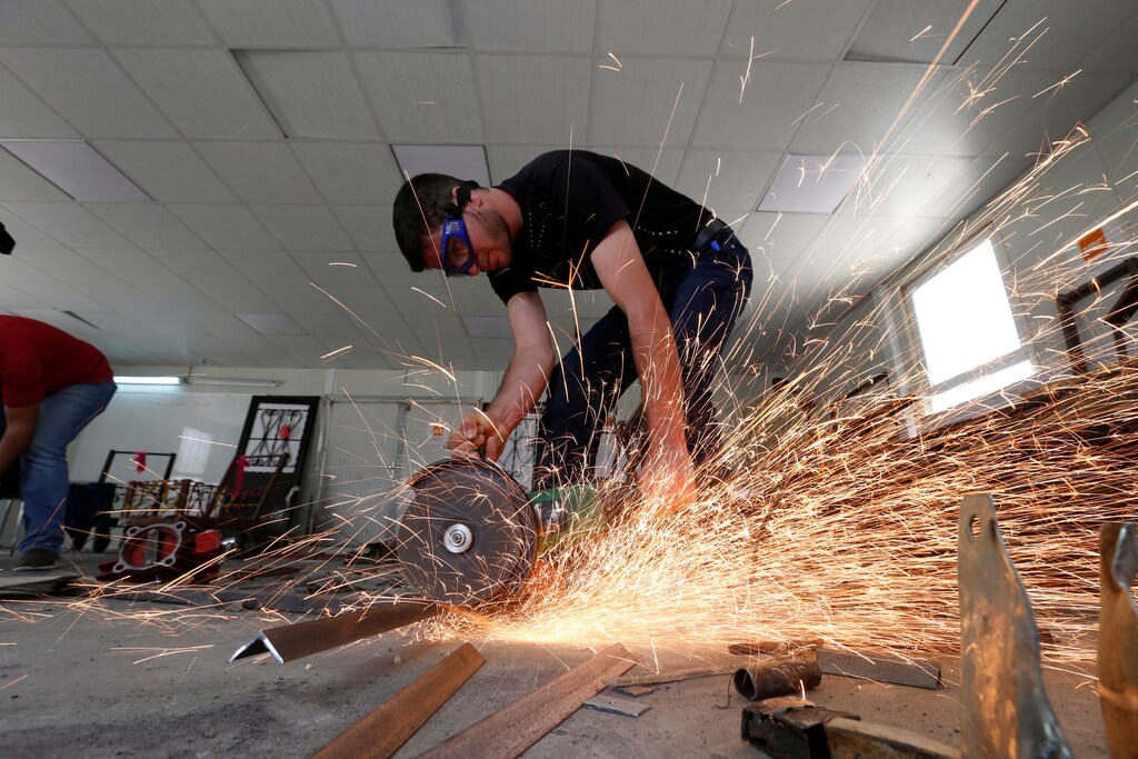 Syrian refugee metal shop trainees work at one of the vocational training centres of The Norwegian Refugee Council (NRC) at Azraq refugee camp near Al Azraq city, Jordan, June 27, 2016. REUTERS/Muhammad Hamed - S1AETMIJSSAA