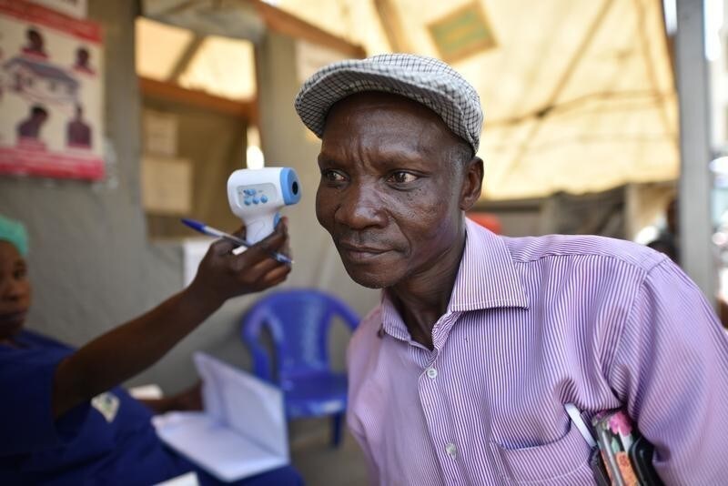 A health worker checks the temperature of a man as part of the ebola screening upon entering the General Hospital in Goma, Democratic Republic of Congo, July 15, 2019. REUTERS/Olivia Acland - RC1E8A7E8140