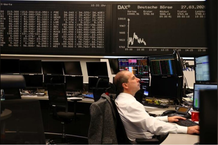 A stock broker works at Frankfurt's stock exchange as markets react on the coronavirus disease (COVID-19), at the stock exchange in Frankfurt, Germany, March 27, 2020.
