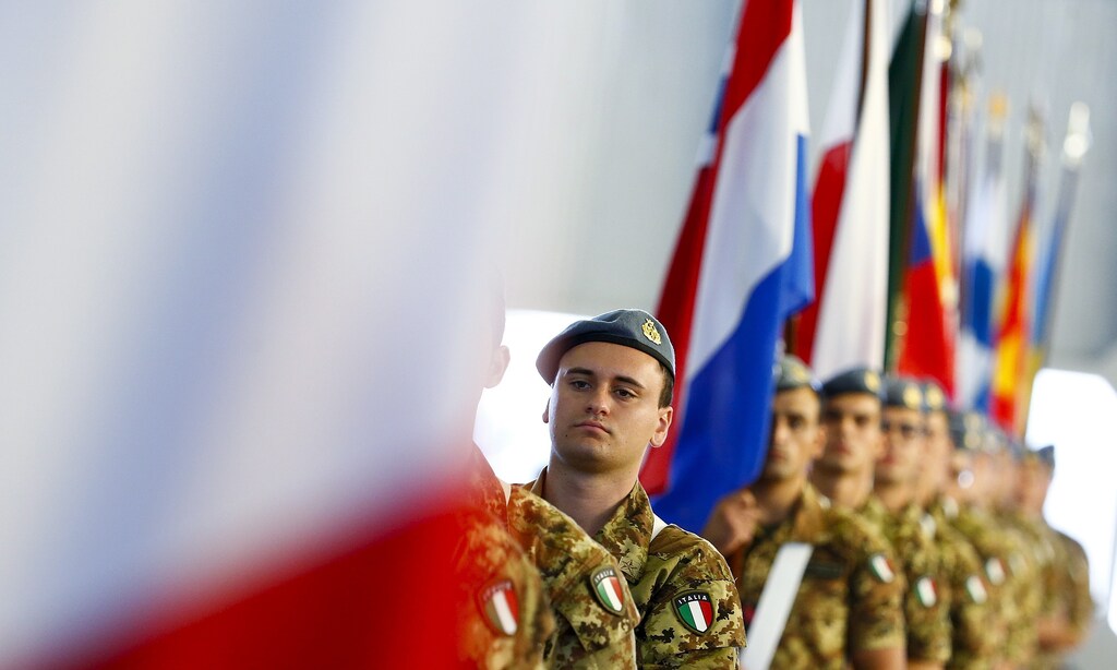 Italian soldiers hold flags during a NATO military exercise at the Birgi NATO Airbase in Trapani, Italy October 19, 2015.
