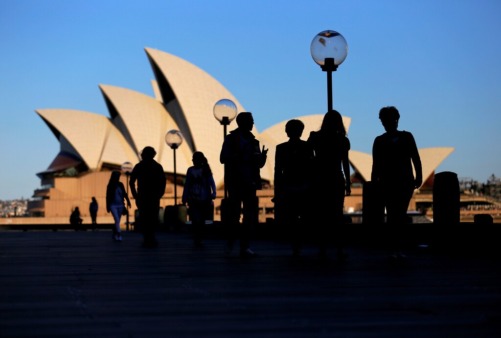People walk in front of the Sydney Opera House, Australia, November 2, 2016. Picture taken November 2, 2016. REUTERS/Steven Saphore - RTS12WL4