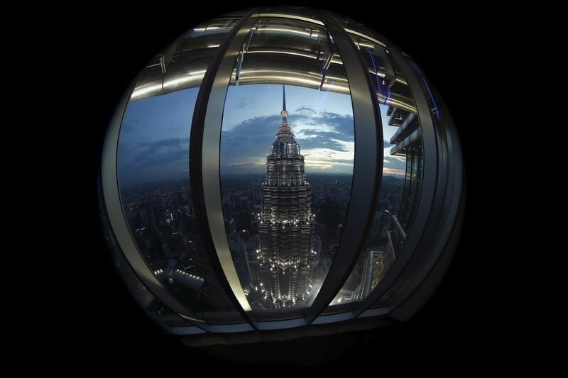 A view of one of the Petronas Towers is seen from windows of its twin building during the Association of Southeast Asian Nations (ASEAN) summit in Kuala Lumpur, Malaysia, November 22, 2015. Picture taken with a fisheye lens. REUTERS/Jorge Silva - RTX1V9UZ