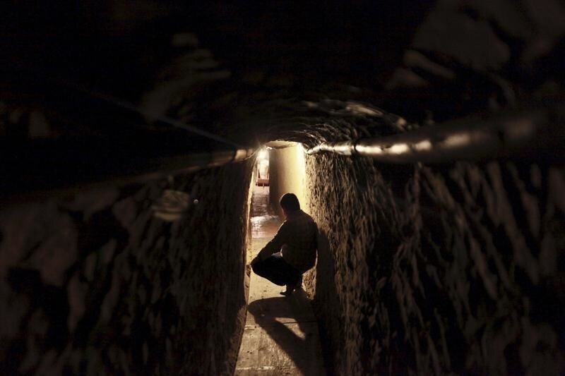 A reporter is seen at a tunnel under construction during a media tour by Mexican Army in Tijuana April 7, 2015. Mexican soldiers foiled the construction of a suspected drug tunnel underneath a house near the U.S. border, arresting nine people and impounding a truck used to clear debris, the Army said on Tuesday. Wired with lights, the tunnel was being built next to the Tijuana border crossing, south of San Diego, California, and near a Mexican air force installation as well as a regional federal police facility. REUTERS/Stringer - GF10000052007