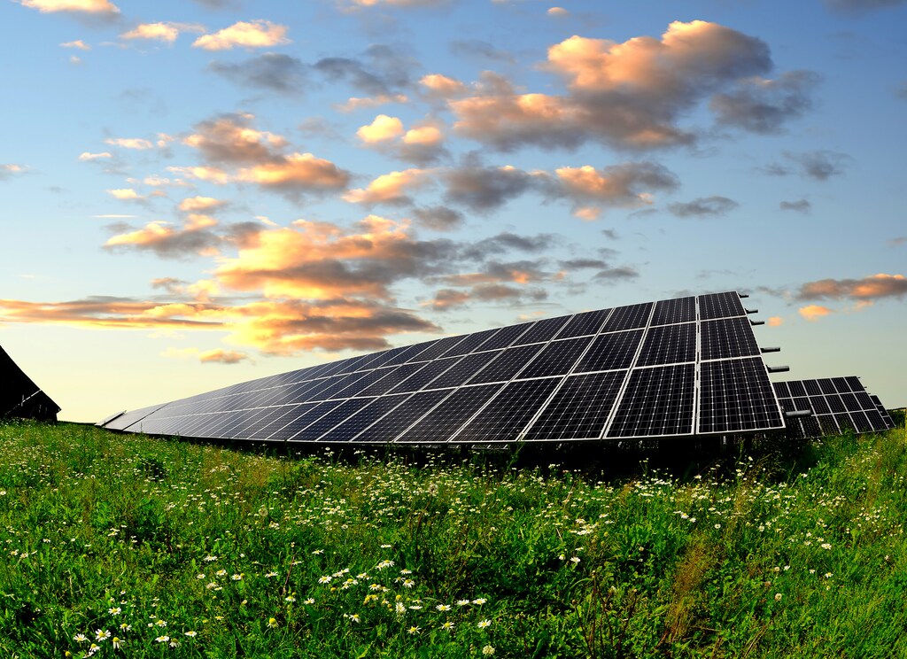 solar panel, green grass, sky and clouds, nature; new energy solutions