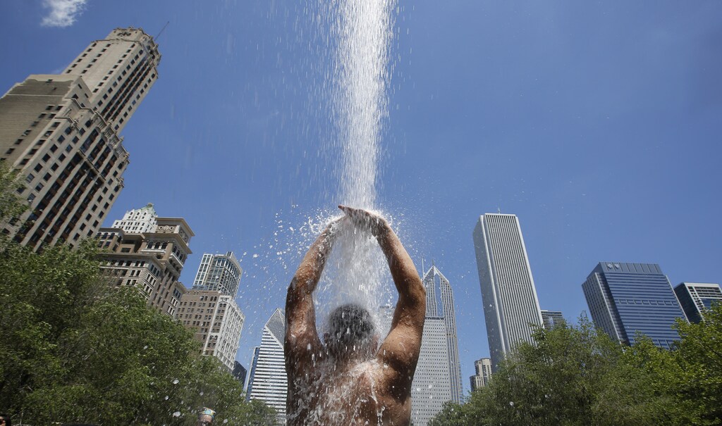 A boy cools off under a water spray from Crown Fountain in downtown Chicago