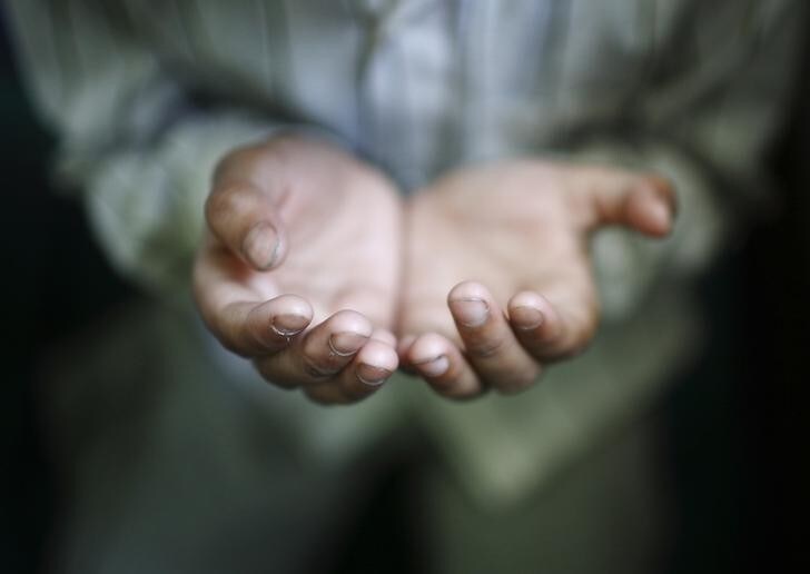 A hand of a Muslim boy offering prayer is pictured during the holy fasting month of Ramadan at Nepali Jame Mashjid in Kathmandu July 26, 2012. REUTERS/Navesh Chitrakar (NEPAL - Tags: RELIGION SOCIETY TPX IMAGES OF THE DAY)