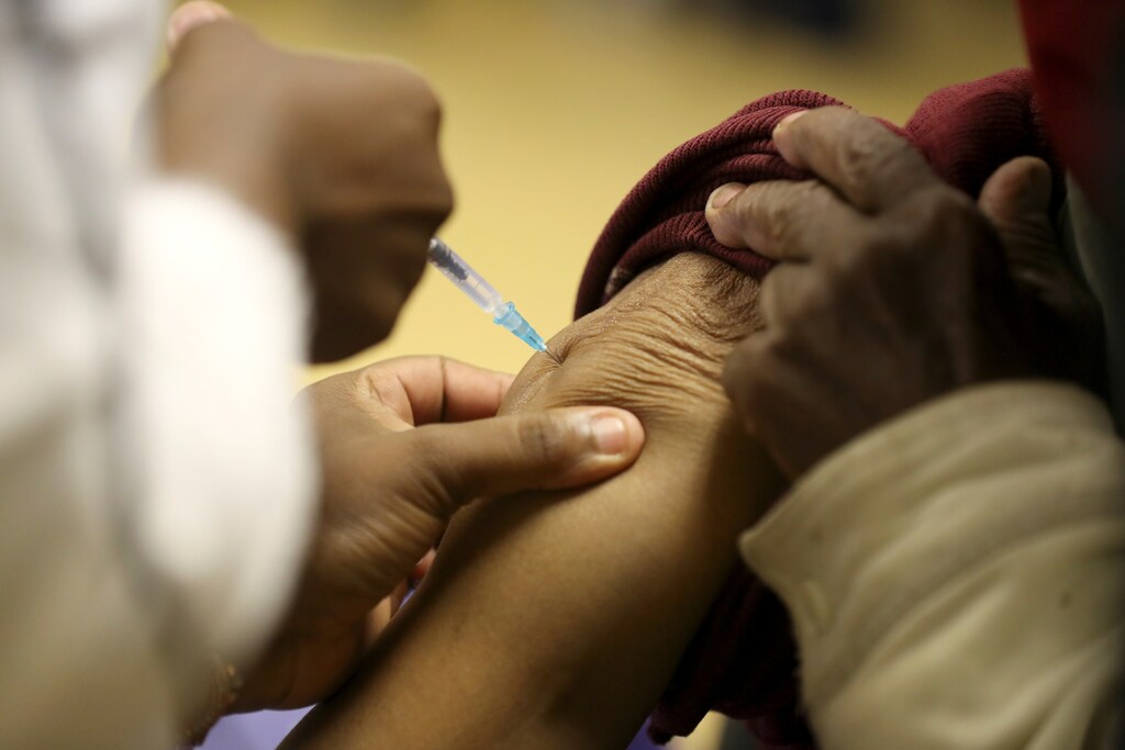A person receives a dose of a coronavirus disease (COVID-19) vaccine, as South Africa rolls out the coronavirus disease (COVID-19) vaccination to the elderly at the Munsieville Care for the Aged Centre outside Johannesburg, South Africa May 17, 2021. REUTERS/Siphiwe Sibeko - RC2LHN9P2Y72