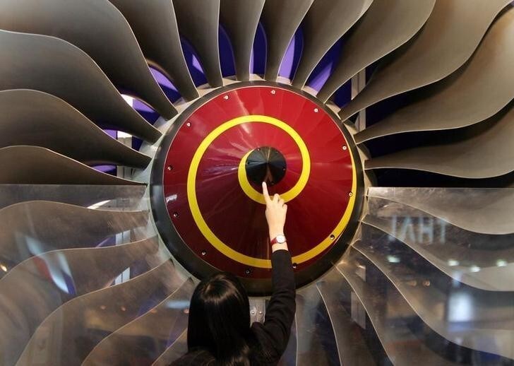 A Chinese visitor touches a Rolls-Royce swept fan on display at the "Aviation Expo China 2005" in Beijing September 22, 2005. Rolls-Royce Group Plc. is taking an even keener interest in China than most western exporters, because of the country's taste for the big airliners that the British company specialises in supplying engines for. The company, the second-largest aero-engine maker, sees the country's aviation industry not only growing unusually fast over the coming 20 years but putting an emphasis on wide-body planes. REUTERS/Claro Cortes IV CC/JJ