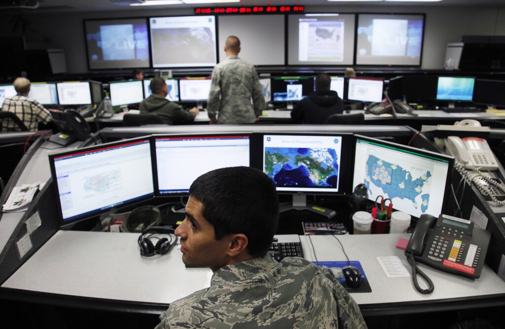 2Lt William Liggett works at the Air Force Space Command Network Operations & Security Center at Peterson Air Force Base in Colorado Springs, Colorado July 20, 2010. U.S. national security planners are proposing that the 21st century's critical infrastructure -- power grids, communications, water utilities, financial networks -- be similarly shielded from cyber marauders and other foes. The ramparts would be virtual, their perimeters policed by the Pentagon and backed by digital weapons capable of circling the globe in milliseconds to knock out targets. To match Special Report USA-CYBERWAR/ REUTERS/Rick Wilking (UNITED STATES - Tags: CRIME LAW MILITARY SCI TECH POLITICS) - RTXT2VZ