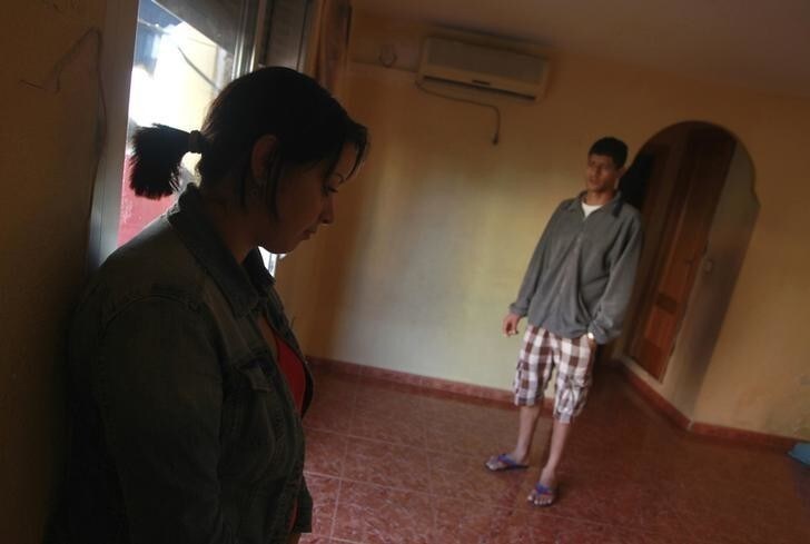 Koutar (L) and Djelloul Banitas stand in their empty home as they wait for the judicial commission to carry out their eviction from the apartment in Sagunto near Valencia, after the family fell behind in their mortgage payments to Spanish nationalized lender Bankia, October 21, 2013. The eviction was later suspended by the court. REUTERS/Heino Kalis (SPAIN - Tags: SOCIETY POLITICS BUSINESS)