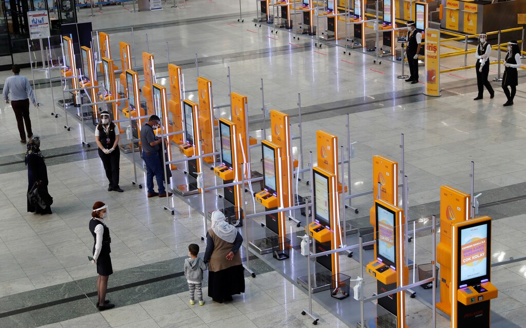 Pegasus Airlines self check-in counters are seen at the nearly empty domestic departure terminal of the Sabiha Gokcen Airport, following the coronavirus disease (COVID-19) outbreak, in Istanbul, Turkey June 11, 2020. REUTERS/Murad Sezer - RC2X6H9AXNI3