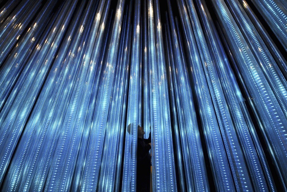 A worker adjusts a lighting installation inside the Chinese Pavilion at the Shanghai World Expo site in Shanghai March 25, 2010. The Shanghai World Expo 2010 is due to run from May 1-Oct 31, with about 70 million visitors expected to attend, according to its official website. Picture taken March 25, 2010. REUTERS/China Daily (CHINA - Tags: BUSINESS TRAVEL IMAGES OF THE DAY) CHINA OUT. NO COMMERCIAL OR EDITORIAL SALES IN CHINA - GM1E63Q10YK01
