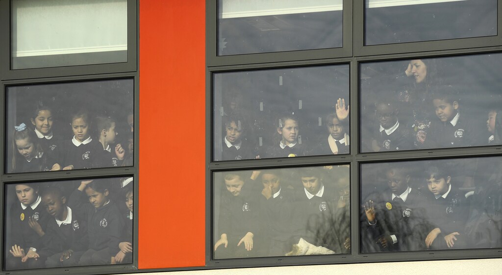 School pupils watch as Britain's Catherine the Duchess of Cambridge and Prince William, the Duke of Cambridge (not pictured) leave an event organised by charity Place2Be during Children's Mental Health Week at Mitchell Brook Primary School in north London, Britain, February 6, 2017. REUTERS/Toby Melville - RTX2ZT8T