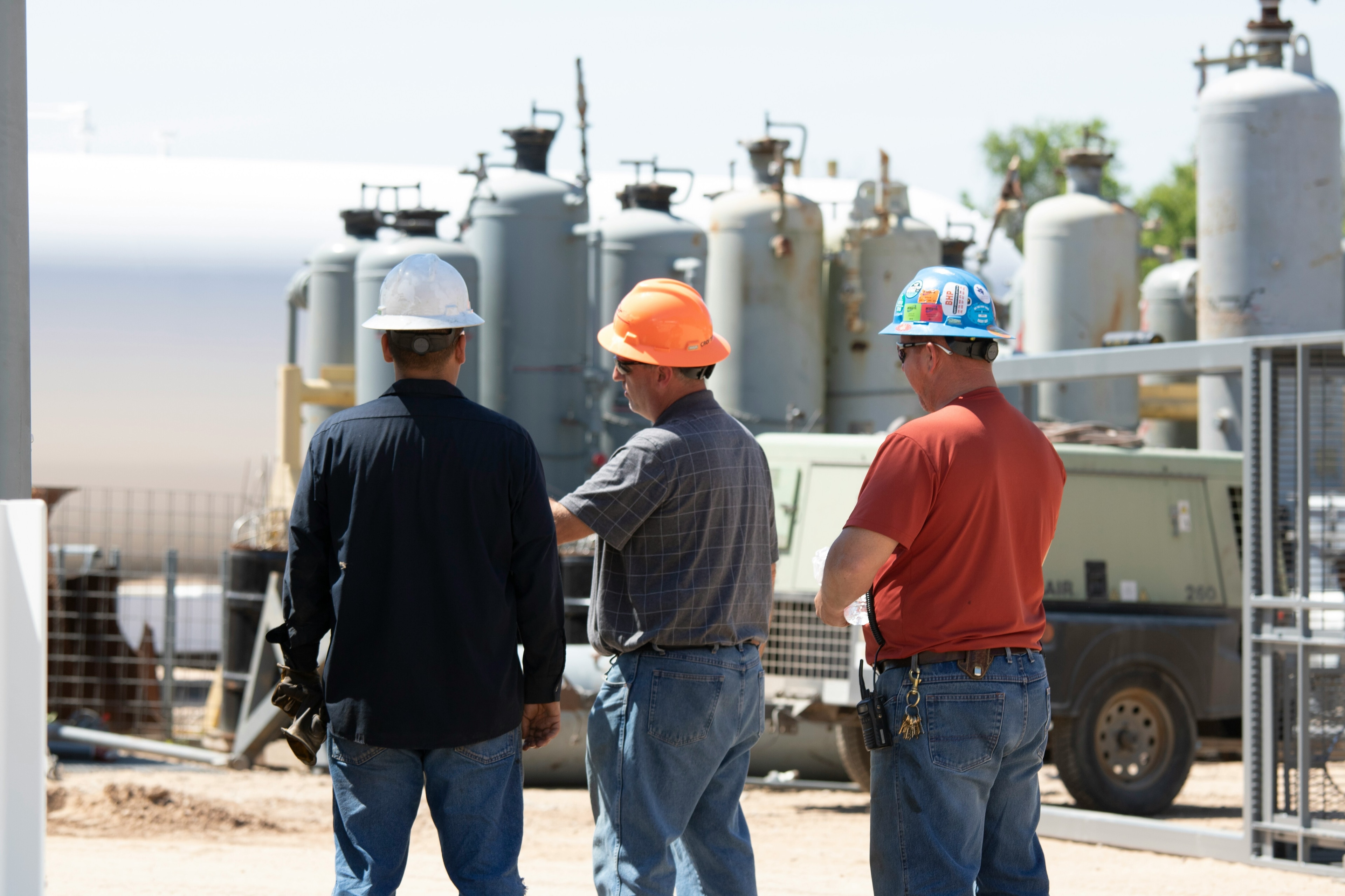 Workers in hardhats, illustrating the need for every worker to be paid a living wage