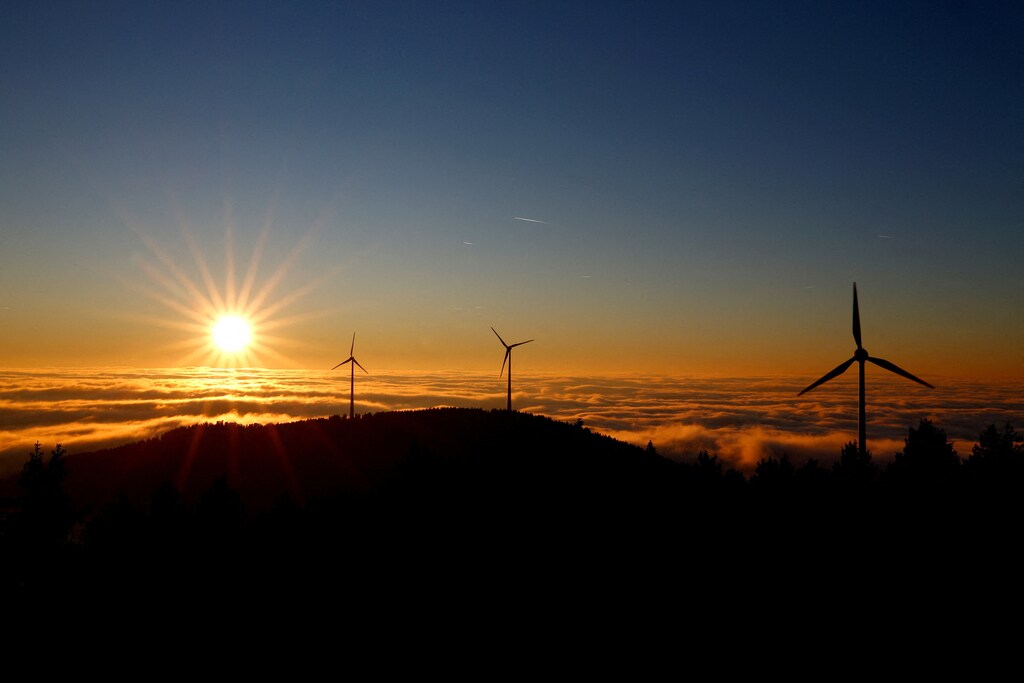 A wind turbine stands out against the sky as the sun sets over the Black Forest Brandenkopf lookout near Oberharmersbach, Germany.
