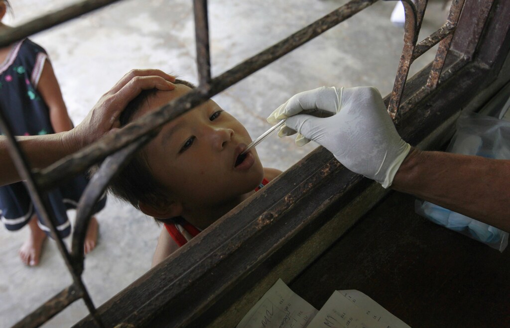 A Thai Public Heath Ministry official places a thermometer into a child's mouth at a malaria clinic in Sai Yoke district, Kanchanaburi Province October 26,2012. The child, who lives on the Thai-Myanmar border, came to the clinic to get tested for malaria. Globally, 3.3 billion people are at risk of malaria infection. While Africa has the highest malaria burden, most the 46,000 deaths outside Africa occurred in Asia Pacific. There are also concerns over a growing parasite resistance. Studies and research show artemisinin-based therapies - currently the most effective treatment against malaria - are taking longer to cure some of the patients. REUTERS/Sukree Sukplang (THAILAND - Tags: POLITICS HEALTH) - GM1E8AQ1CJ801