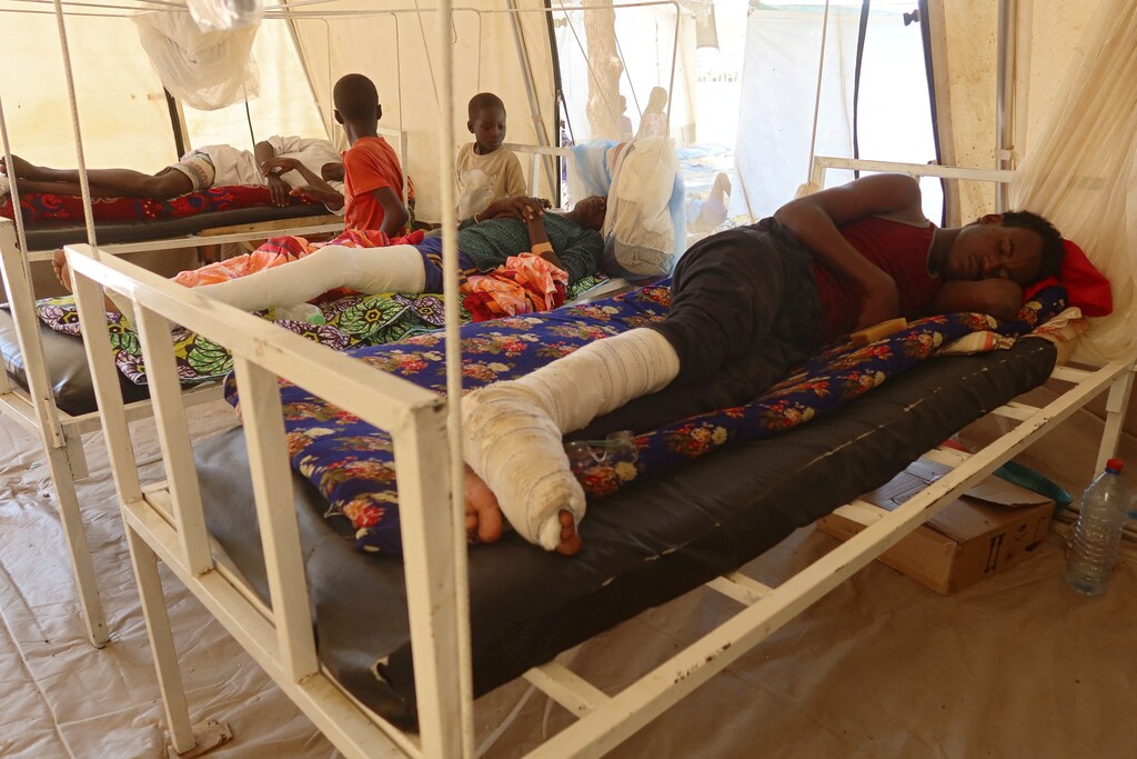 A wounded man lies in a Doctors Without Borders hospital, where refugees receive treatment after fleeing ethnic violence in Ardamata, West Darfur, in the border town of Adre, Chad November 10, 2023. Upcoming talks on the Sudan war in Geneva could alleviate the suffering of millions of Sudanese people.