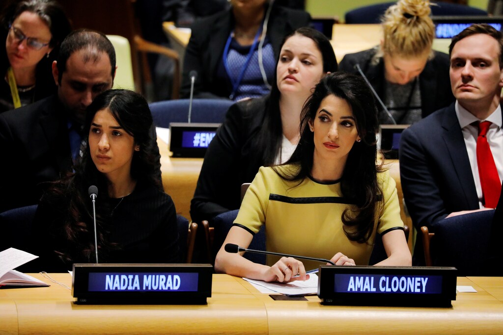 International human rights lawyer Amal Clooney (C) sits with Nadia Murad as she waits to address a Bringing Daesh to Justice event at United Nations headquarters in New York, U.S., March 9, 2017. REUTERS/Lucas Jackson - RTS127MI