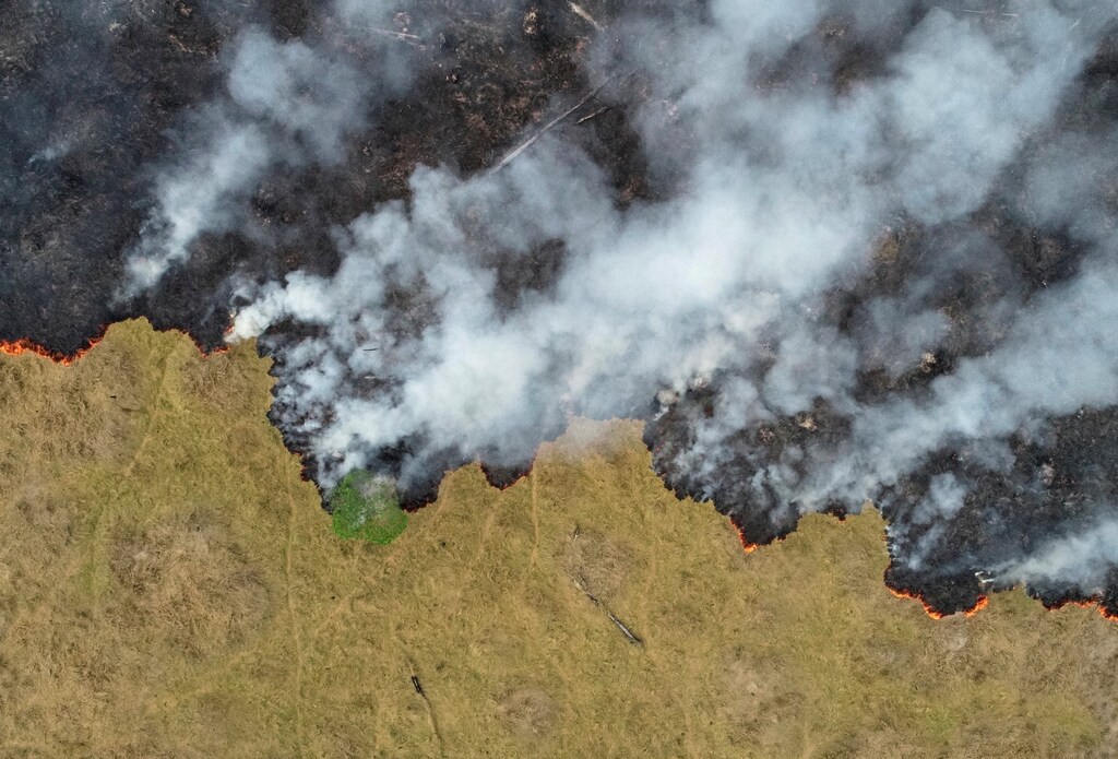 An aerial view shows smoke rising over a deforested plot of the Amazon jungle in Porto Velho, Rondonia State, Brazil, in this August 24, 2019 picture taken with a drone. Picture taken August 24, 2019. REUTERS/Ueslei Marcelino TPX IMAGES OF THE DAY - RC180A432CE0