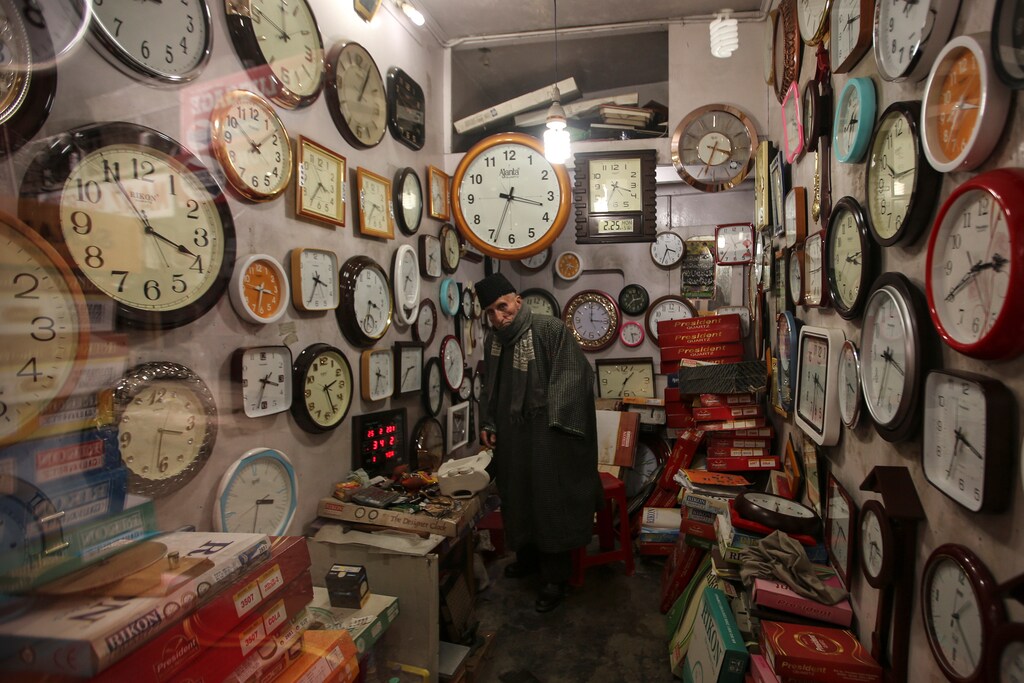 A vendor looks out of his clock shop in Srinagar, February 25, 2019. REUTERS/Danish Ismail - RC152FCB9B70