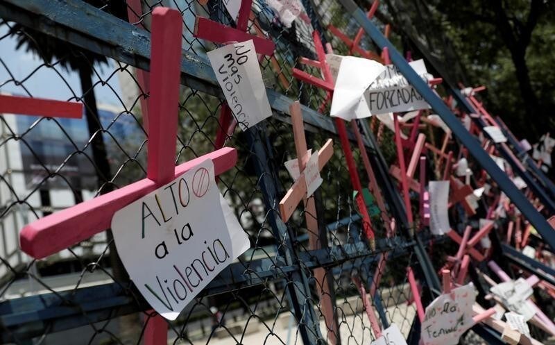 Pink crosses with messages against violence against women hang on a fence outside the U.S Embassy on Reforma Avenue in Mexico City, Mexico March 21, 2018.