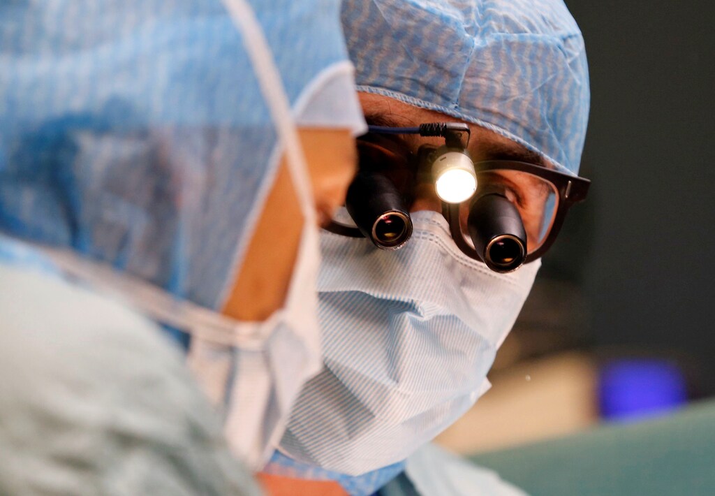 A heart surgeon performs an operation in an operating room at the Saint-Augustin clinic in Bordeaux, France, October 25, 2018