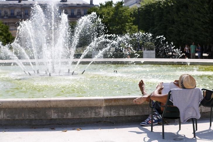 A man enjoys the sun sitting in a chair in the Palais Royal Garden in central Paris, France, July 1, 2015. A widespread, long-lasting heat wave will spread across much of France, U.K., Belgium, the Netherlands and western Germany with forecast highs on Wednesday reaching 35 degrees Celsius (95 degrees Fahrenheit). REUTERS/Charles Platiau