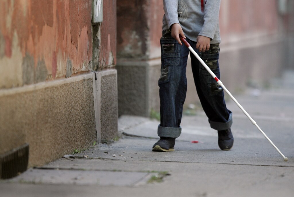 A blind boy walks with a white stick on World Sight Day in Belgrade October 12, 2006. World Sight Day is a global annual event, held under the auspices of "VISION 2020: The Right to Sight," a joint initiative of the World Health Organization and the International Agency for the Prevention of Blindness. REUTERS/Marko Djurica (SERBIA) - GM1DTRWWOZAA