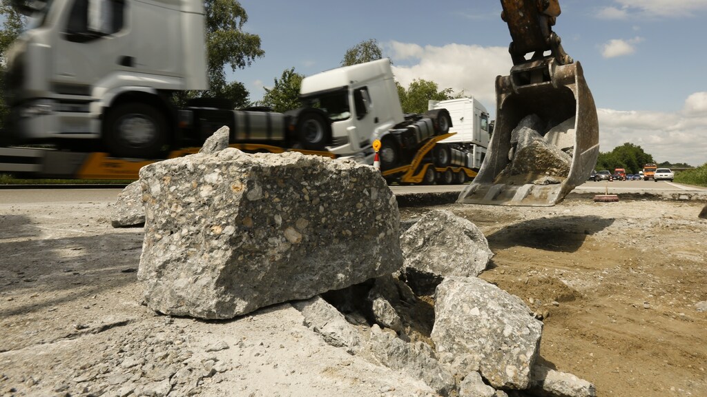 n excavator removes broken concrete parts on the A3 motorway between Deggendorf and Passau near the south eastern Bavarian town of Hengersberg June 21, 2013.