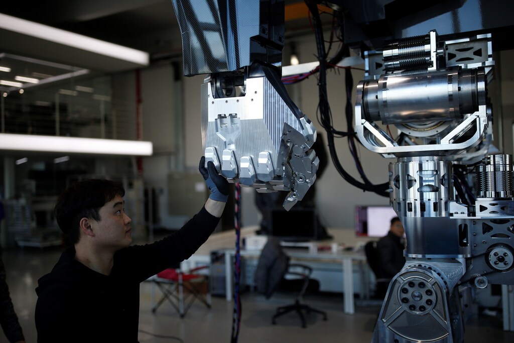Employees check a manned biped walking robot "METHOD-2" during a demonstration in Gunpo, South Korea, December 27, 2016.