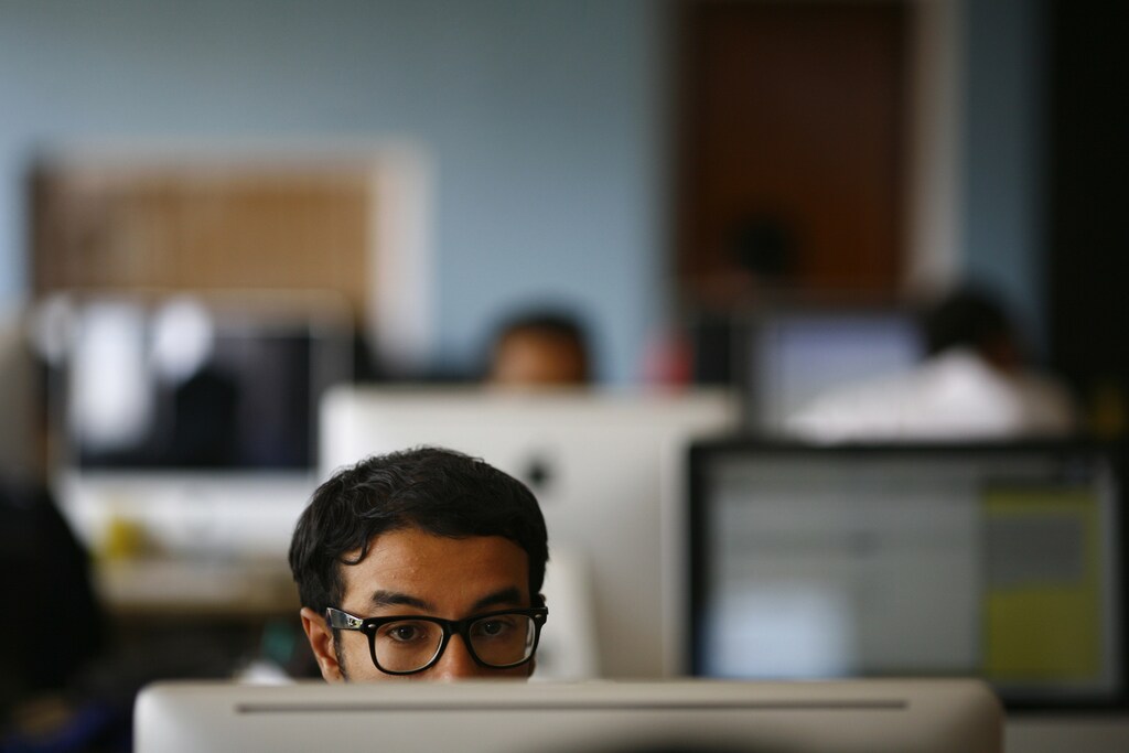 An employee works on his computer at the office of CloudFactory, a Canadian startup that based itself in Kathmandu, where it hires teams of Nepalese October 5, 2012. Not far from the world of regimented cubicles and headset-toting call centre operators, a quiet revolution is stirring in its slippers. While it's early days, proponents of so-called commercial crowdsourcing contend that a swelling army of global freelancers is already disrupting traditional outsourcing - from preparing tax statements to conducting research on pediatricians. Picture taken October 5, 2012. To match story ASIA-FREELANCE/ REUTERS/Navesh Chitrakar (NEPAL - Tags: SOCIETY BUSINESS) - RTR39017