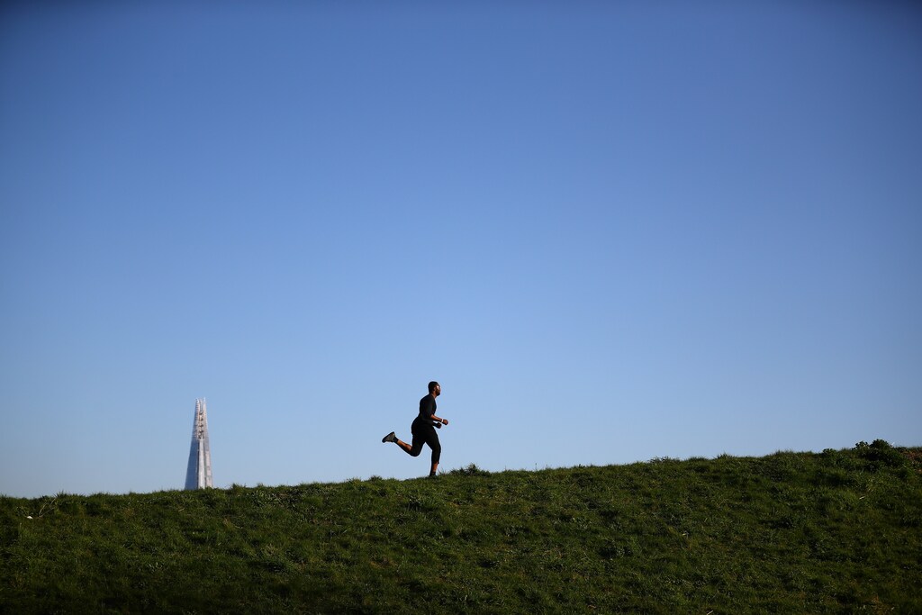 A runner is seen in Burgess Park, as the spread of coronavirus disease (COVID-19) continues in London, Britain, March 25, 2020. REUTERS/Hannah McKay - RC2WQF95Q1OV