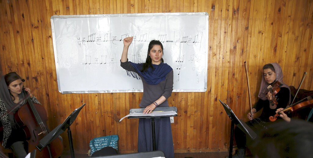 Negin Khpulwak, leader of the Zohra orchestra, an ensemble of 35 women, conducts during a rehearsal at Afghanistan's National Institute of Music, in Kabul, Afghanistan April 9, 2016. Playing instruments was banned under Taliban rule in Afghanistan, and even today, many conservative Muslims frown on most forms of music. Living in an orphanage in the capital, Kabul, 19-year-old Negin leads an ensemble of 35 women that plays both Western and Afghan musical instruments. In a country notorious internationally for harsh restrictions on women in most areas of life, Negin's story highlights a double challenge. REUTERS/Ahmad Masood SEARCH "ORCHESTRA KABUL" FOR THIS STORY. SEARCH "THE WIDER IMAGE" FOR ALL STORIES - GF10000383703